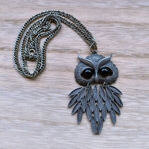 This is a vintage owl pendant necklace featuring a stylized owl